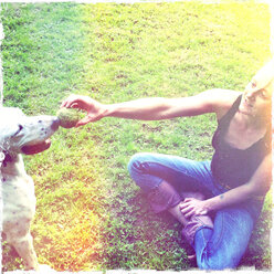 In the garden, woman animates dog to the ball game, Dalmatian mix - ONF000379