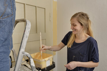 Young woman painting her apartment - LAF000414