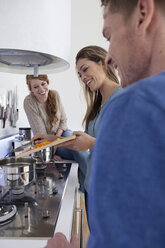 Three friends cooking together - RBF001529