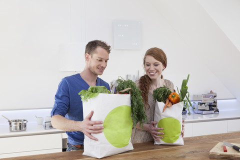 Couple holding shopping bags with purchases stock photo