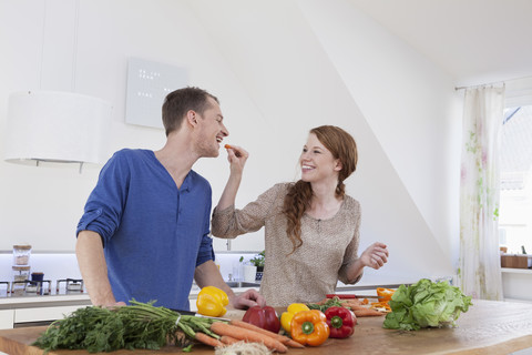 Junges Paar bereitet Essen in der Küche vor, lizenzfreies Stockfoto