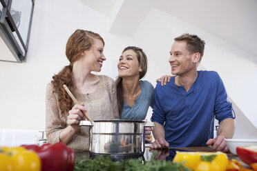 Three friends cooking together - RBF001587