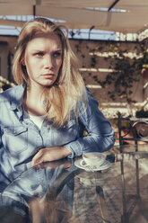 Italy, Sicily, Palermo, Blonde woman sitting in cafe - MFF000740