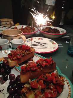 New Years eve food with sparkler, Palermo, Sicily, Italy - MEAF000082