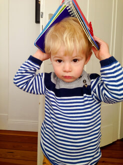 Kleiner Junge mit Buch auf dem Kopf - MEAF000074