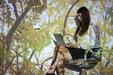 Young woman in nature projection using laptop - BGF000082