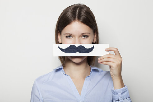 Young woman covering part of face with painted moustache - BGF000049