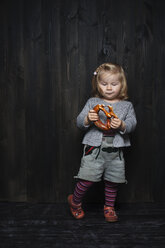 Germany, Hesse, Hofheim, Toddler with Bavarian Leather Shorts and Pretzel - IPF000006