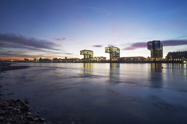 Germany, North Rhine-Westphalia, Cologne, Crane houses at Rheinau harbour by twilight - JATF000566