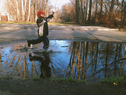 Little boy has found a puddle. Berlin, Germany. - ZMF000096