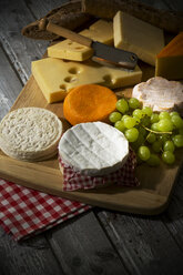 Cheese platter, different cheese, french cheddar, french soft cheese, french sheep cheese, camembert, emmentaler, and austrian mountain cheese and wholemeat baguette on wooden board - MAEF007649