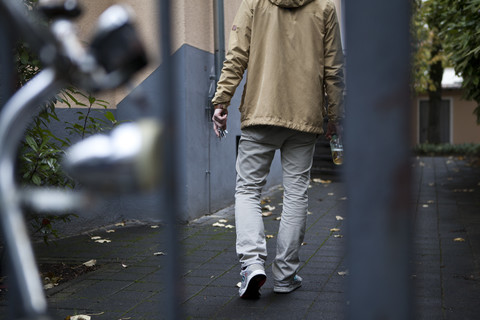 Young man coming home, partial view stock photo