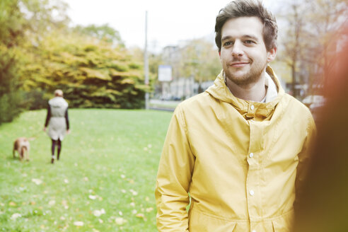 Portrait of smiling young man on grass verge - FEXF000071