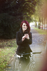 Portrait of smiling woman using smartphone - FEXF000069