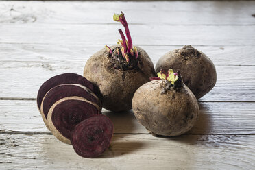 Ganze und in Scheiben geschnittene Rote Bete auf dem Holztisch - SARF000195