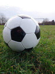 Cologne, North Rhine-Westphalia, Germany, football lying in the grass soccer field - JATF000614