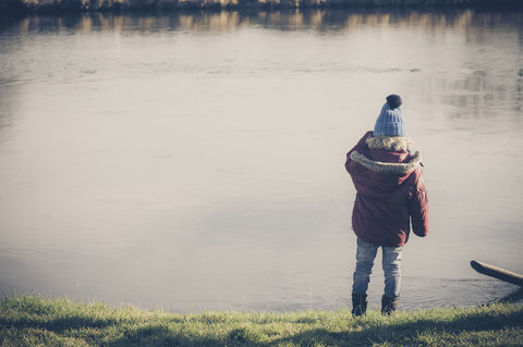 Boy standing at a lake stock photo