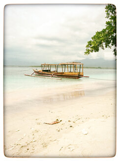 Indonesia, Gili Islands, Beach with traditional fishing boat - KRPF000107