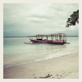 Indonesia, Gili Islands, Beach with traditional fishing boat - KRPF000106