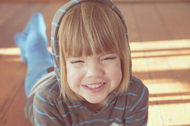 Portrait of twinkling little girl with hoodie sweater - LVF000487