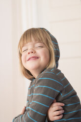 Portrait of smiling little girl with closed eyes wearing hoodie sweater - LVF000491