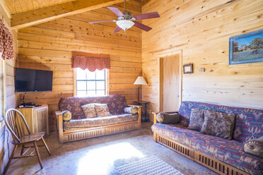 USA, Texas, rustic log house, living room, interior - ABAF001182