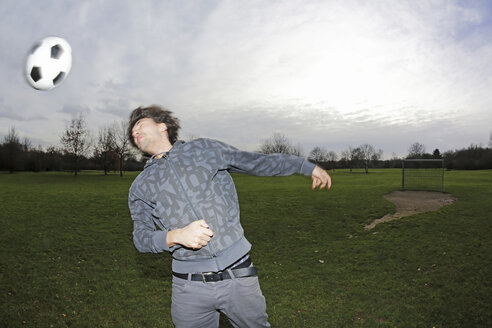 Young man heading a football - JATF000628