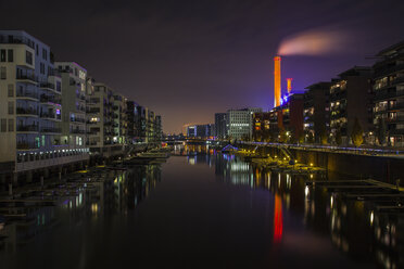 Germany, Hesse, Frankfurt, Residential buildings at Westhafen at night - TIF000021