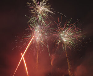 Germany, Bavaria, Kochel am See, fireworks at night sky - LAF000475