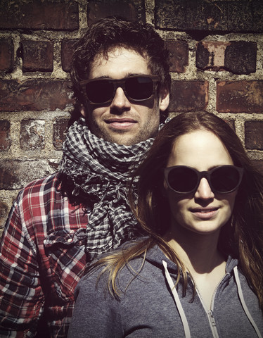 Portrait of young couple wearing wooden sunglasses stock photo