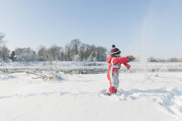 Germany, little boy having fun with snow - MJF000783