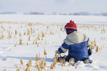 Germany, little boy having fun in snow - MJF000809