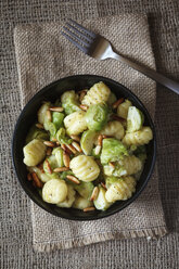 Bowl of brussels sprouts gnocchi with pine nuts on jute - EVGF000353