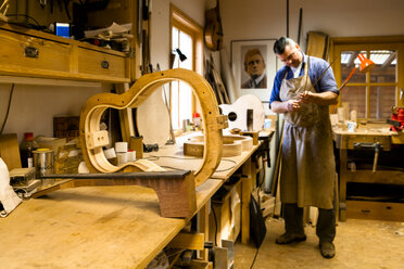 Guitar maker in his workshop - TC003838