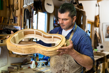 Guitar maker in his workshop - TC003854