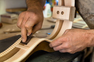 Guitar maker in his workshop, close-up - TC003860