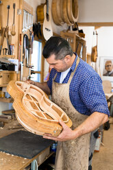 Guitar maker in his workshop - TC003862
