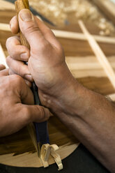 Guitar maker in his workshop, close-up - TC003864