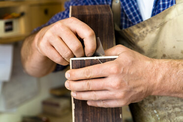 Guitar maker in his workshop, close-up - TC003868