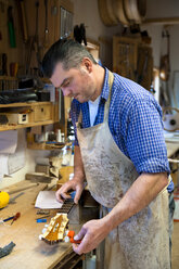 Guitar maker in his workshop - TC003894