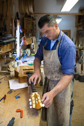 Guitar maker in his workshop - TC003903