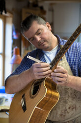 Guitar maker in his workshop - TC003889