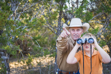 USA, Texas, Man and kid with binoculars - ABAF001205