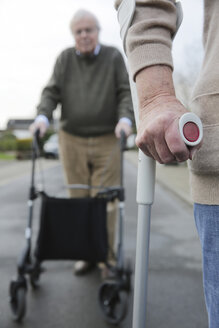 Senior couple with wheeled walker and crutch - JATF000657