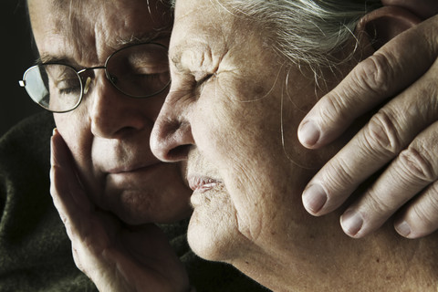Portrait of senior couple with close eyes, close-up stock photo