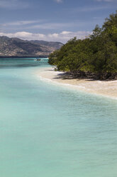 Indonesia, View to Lombok from Isle Gili Air, traditional wooden boat at beach - KRP000219