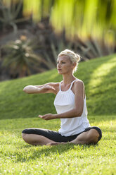 Woman practicing yoga on meadow - EGF000116