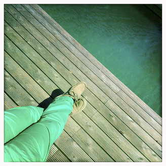 Legs on wooden pier, swimming pond, Lower Austria, Austria - DISF000576