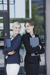 Zwei selbstbewusste Geschäftsfrauen vor einem Bürogebäude - CHAF000054