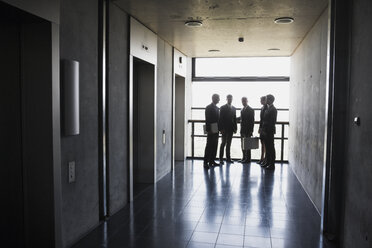 Group of businesspeople standing at elevator - CHAF000087